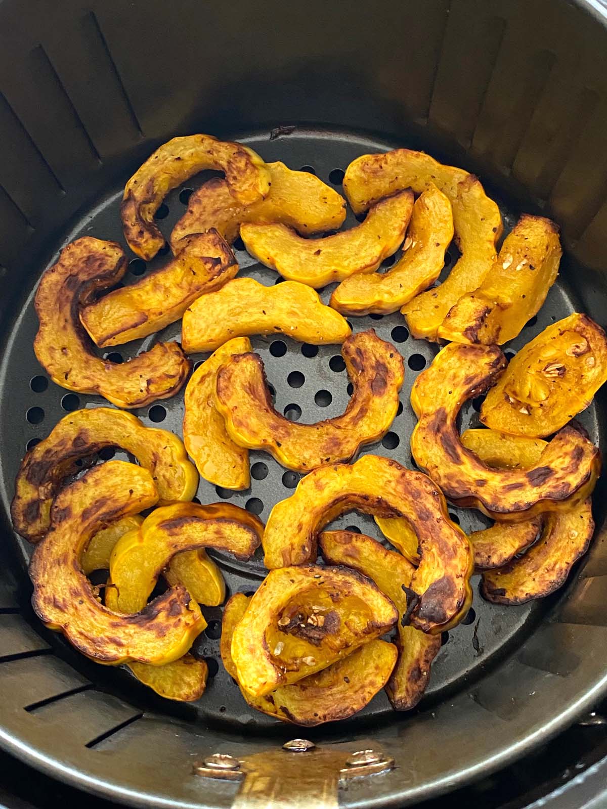 Cooked delicata squash in an air fryer.