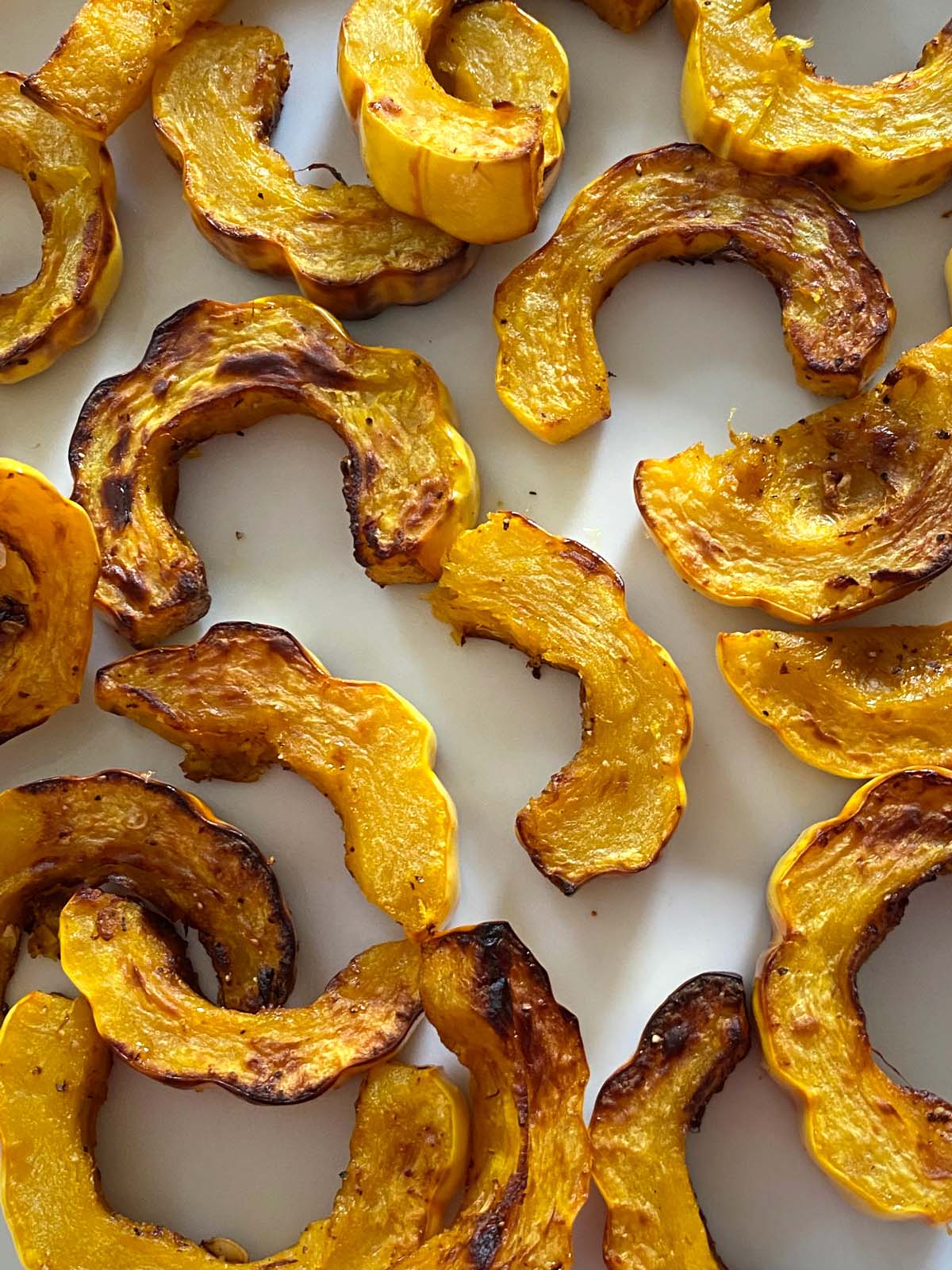 Air fried delicata squash on a white plate.