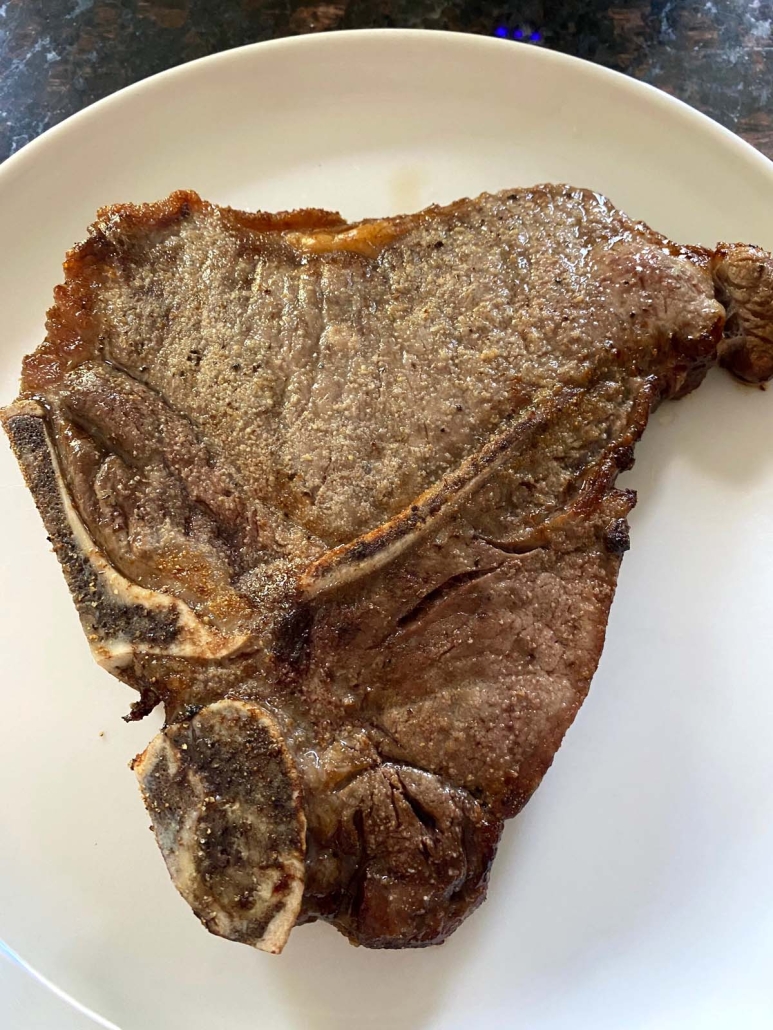 cooked t-bone steak on a plate