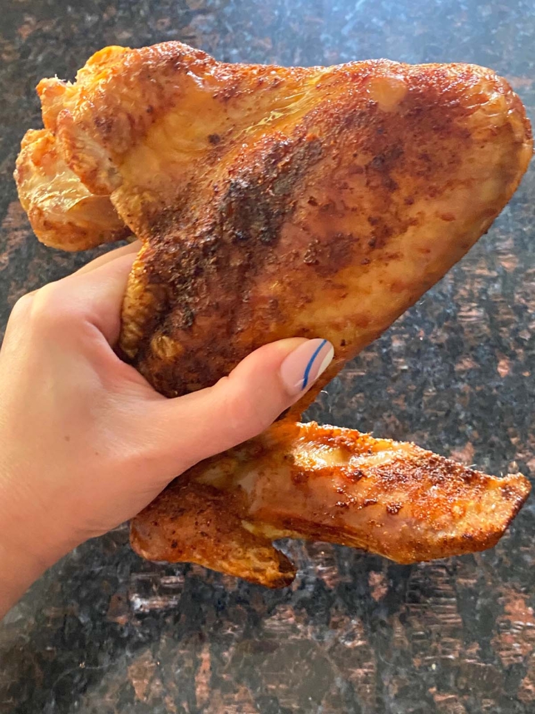 hand holding cooked turkey wing