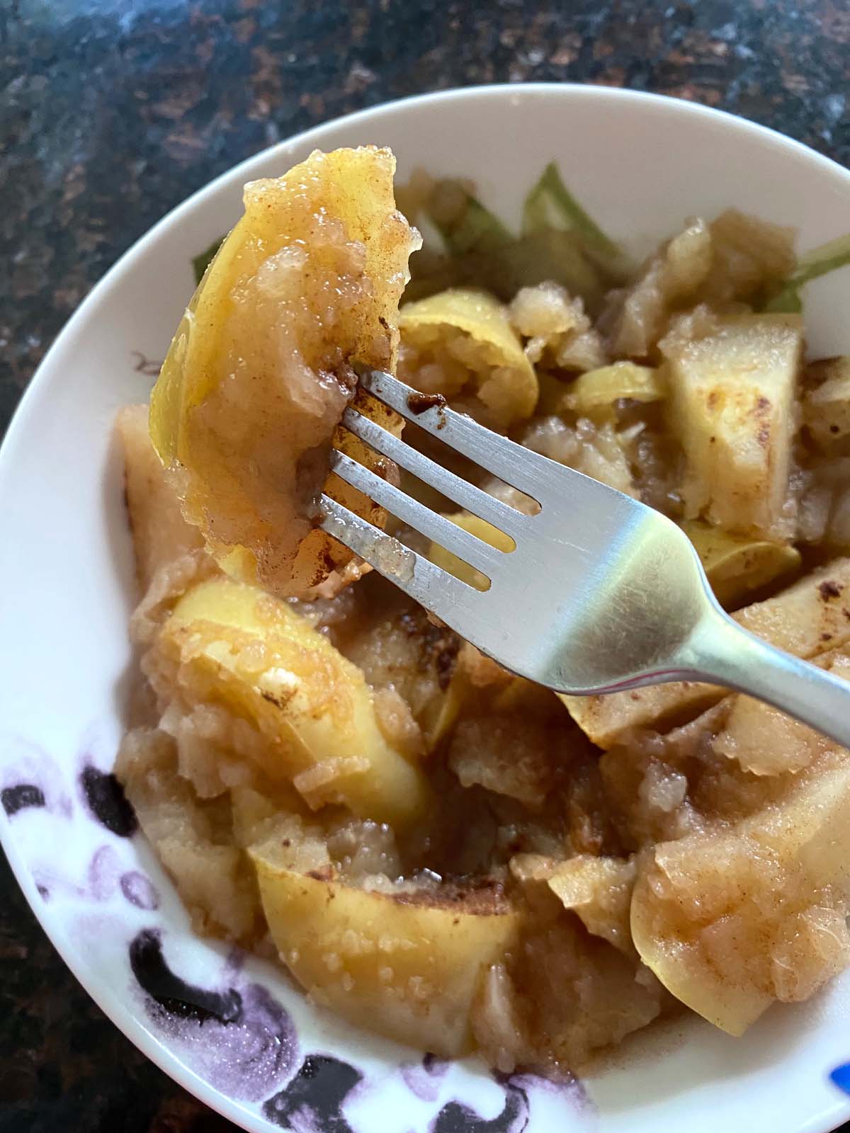 Cooked cinnamon apples in a bowl. 