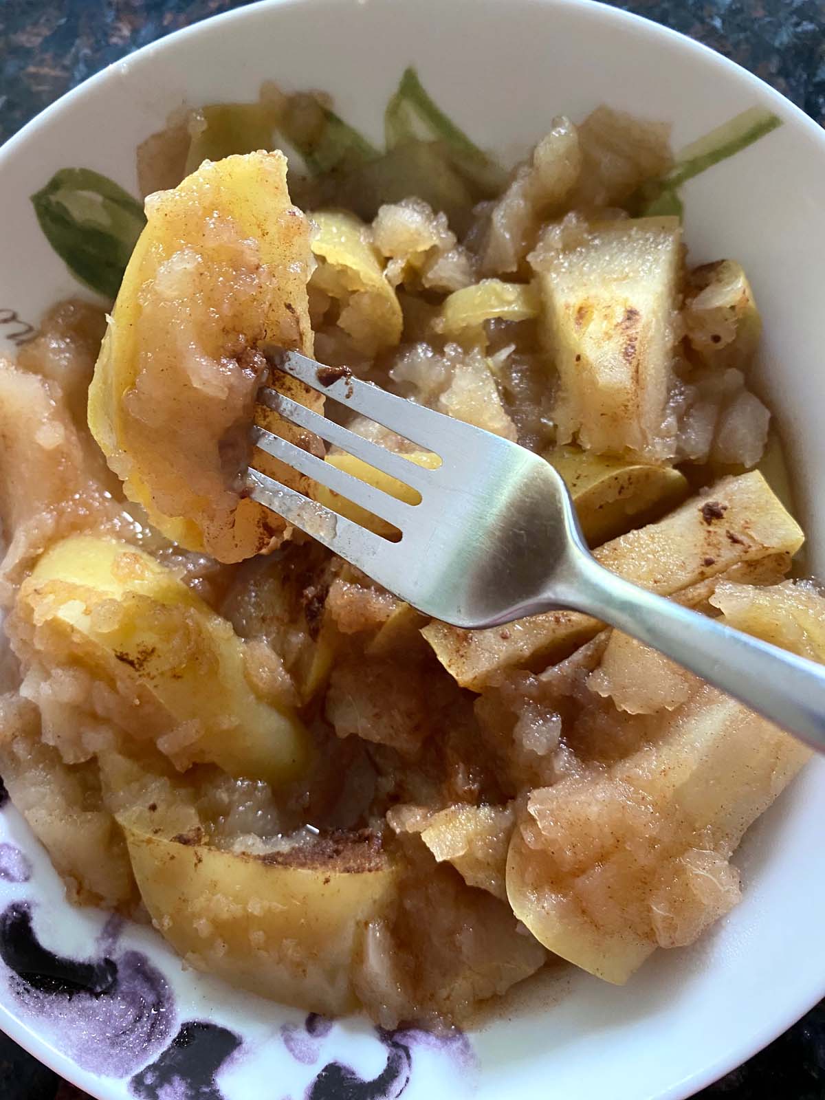 Cooked cinnamon apples in a bowl. 