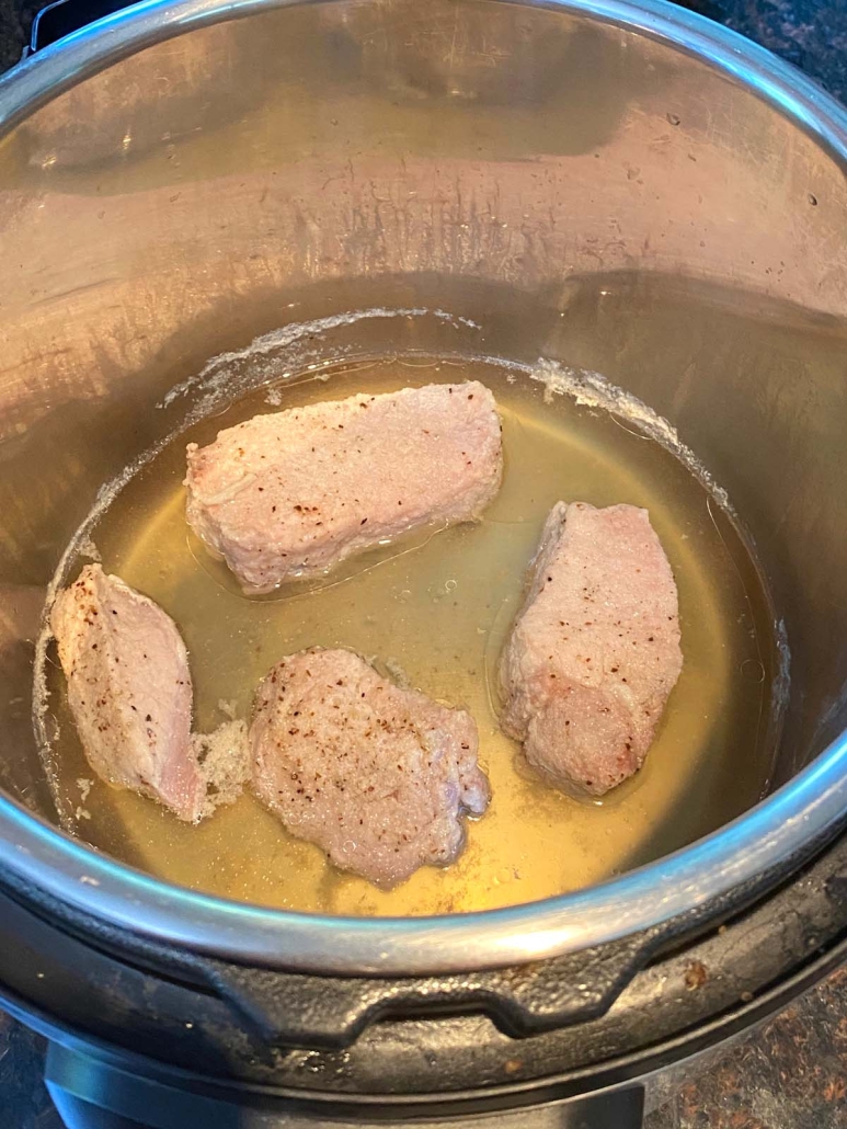 country style pork ribs in water at bottom of instant pot