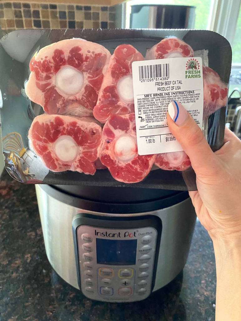 raw oxtails in a package next to an instant pot
