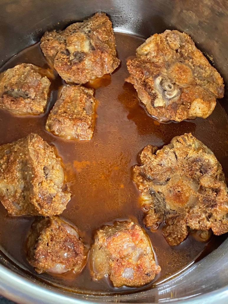 instant pot opened to show cooked oxtails