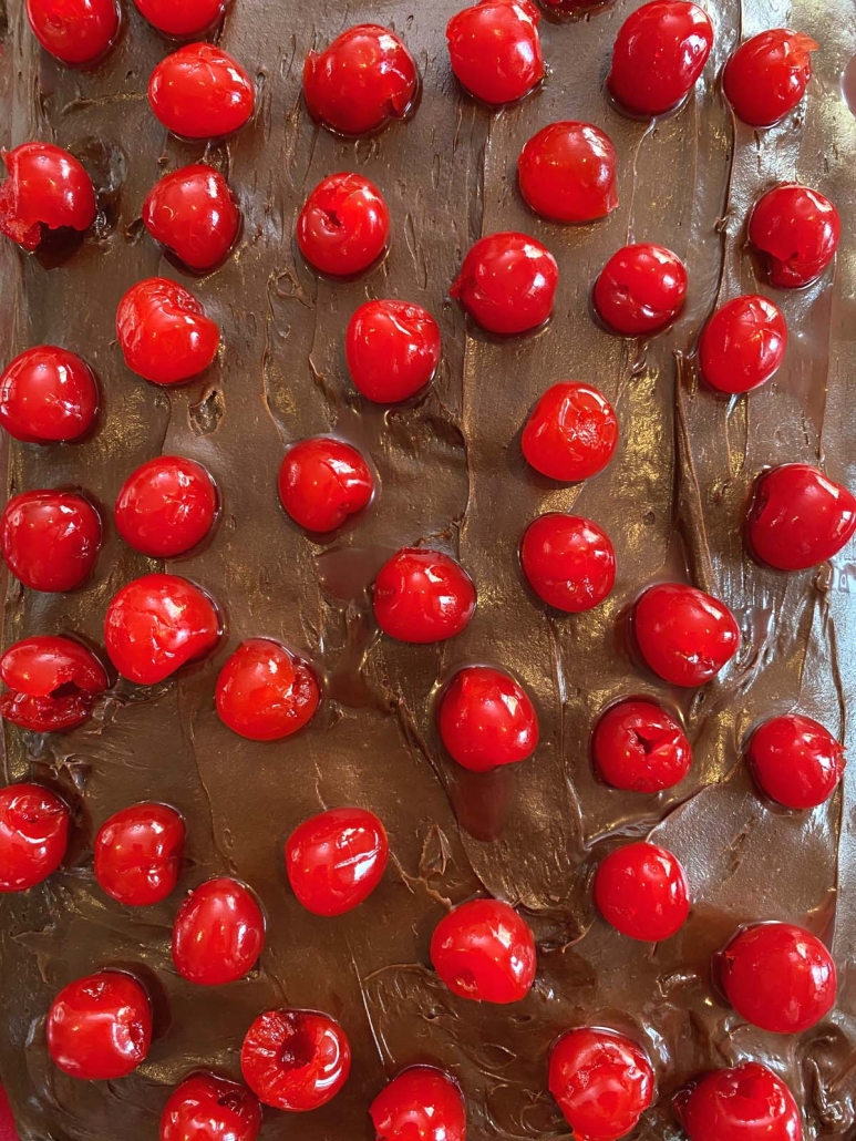 close-up of cherries on chocolate cake