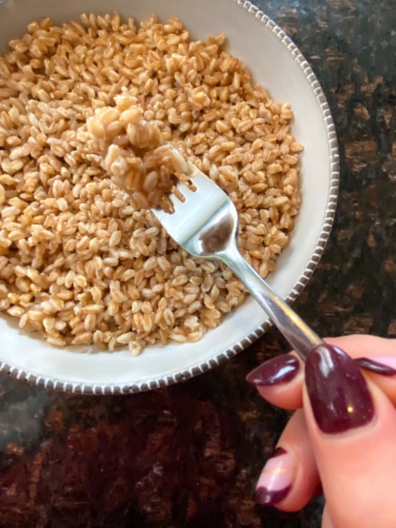 fork scooping up cooked farro
