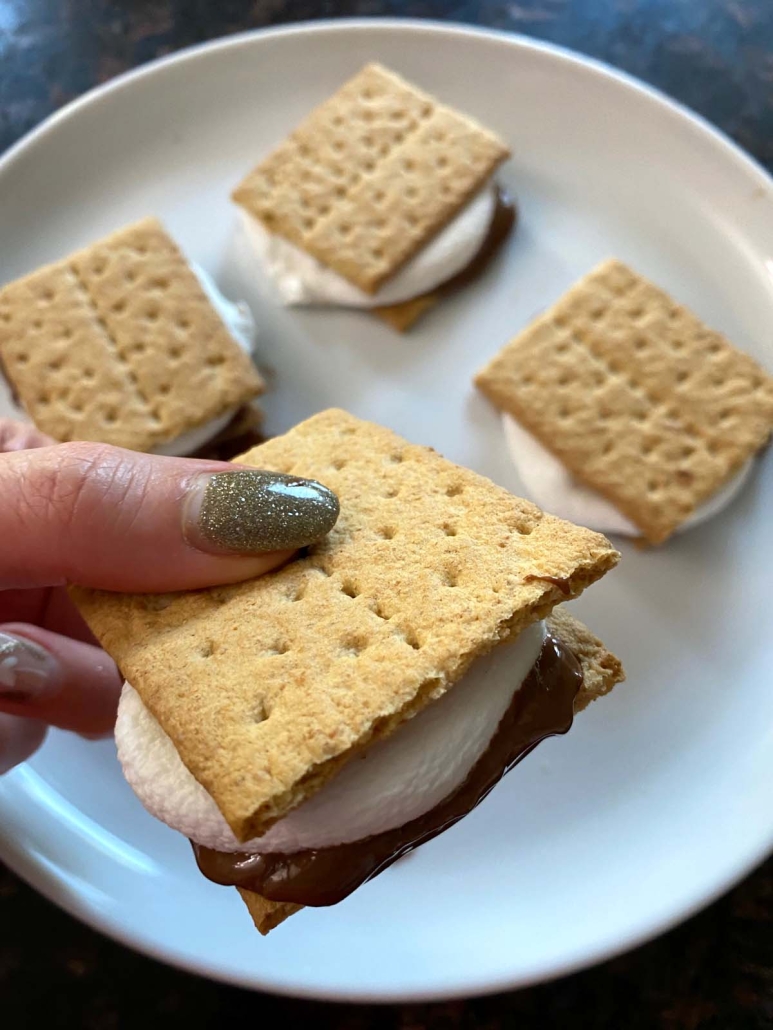 hand holding microwaved s'mores