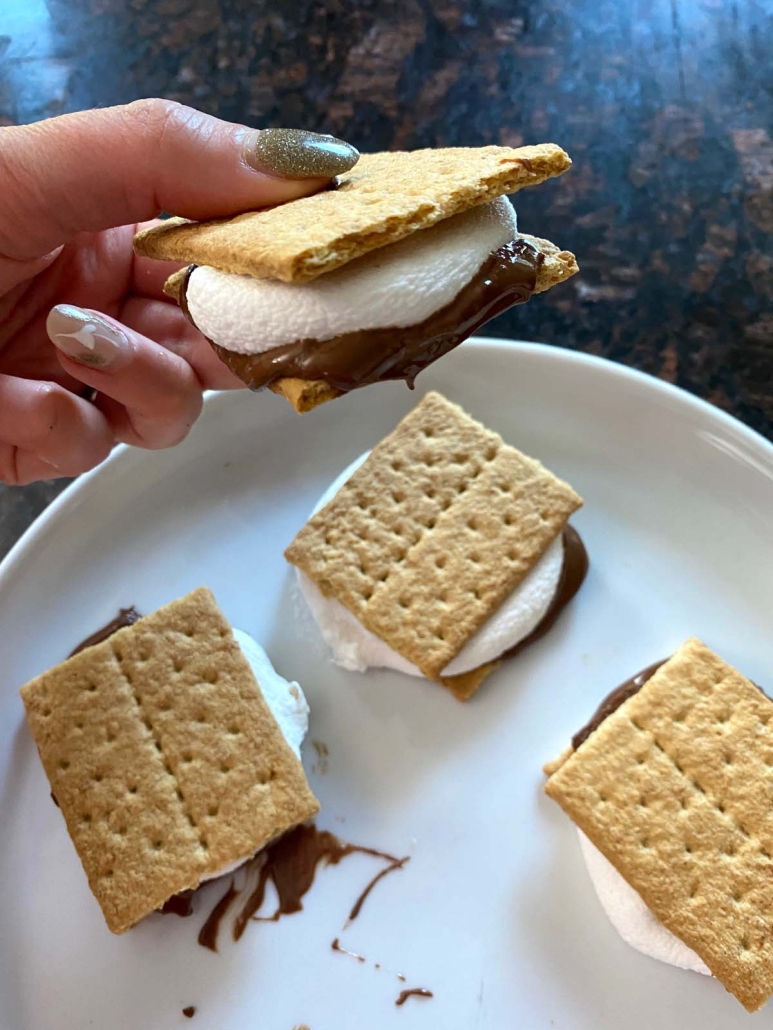 hand holding s'more made in microwave