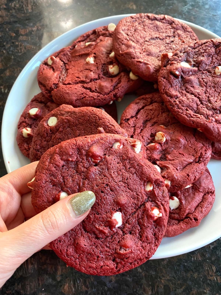 hand holding red velvet cookie