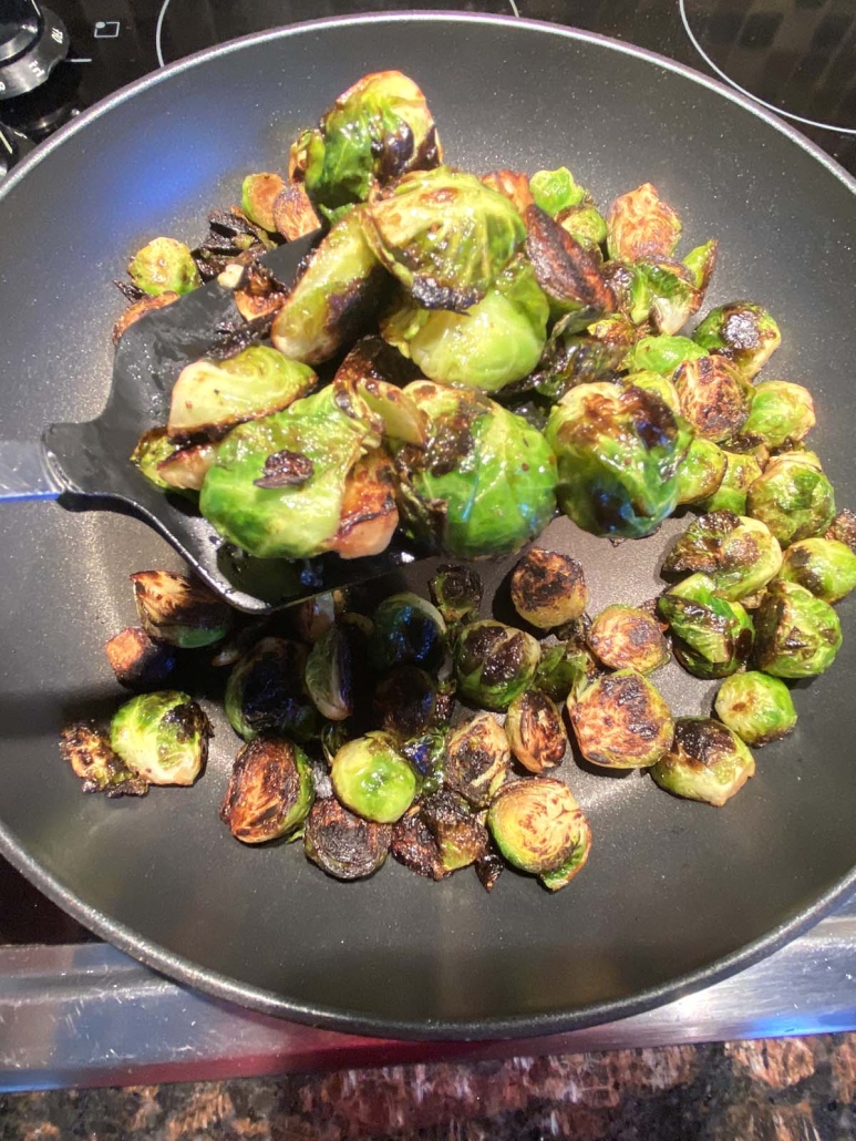 spatula stirring up cooked Brussels sprouts