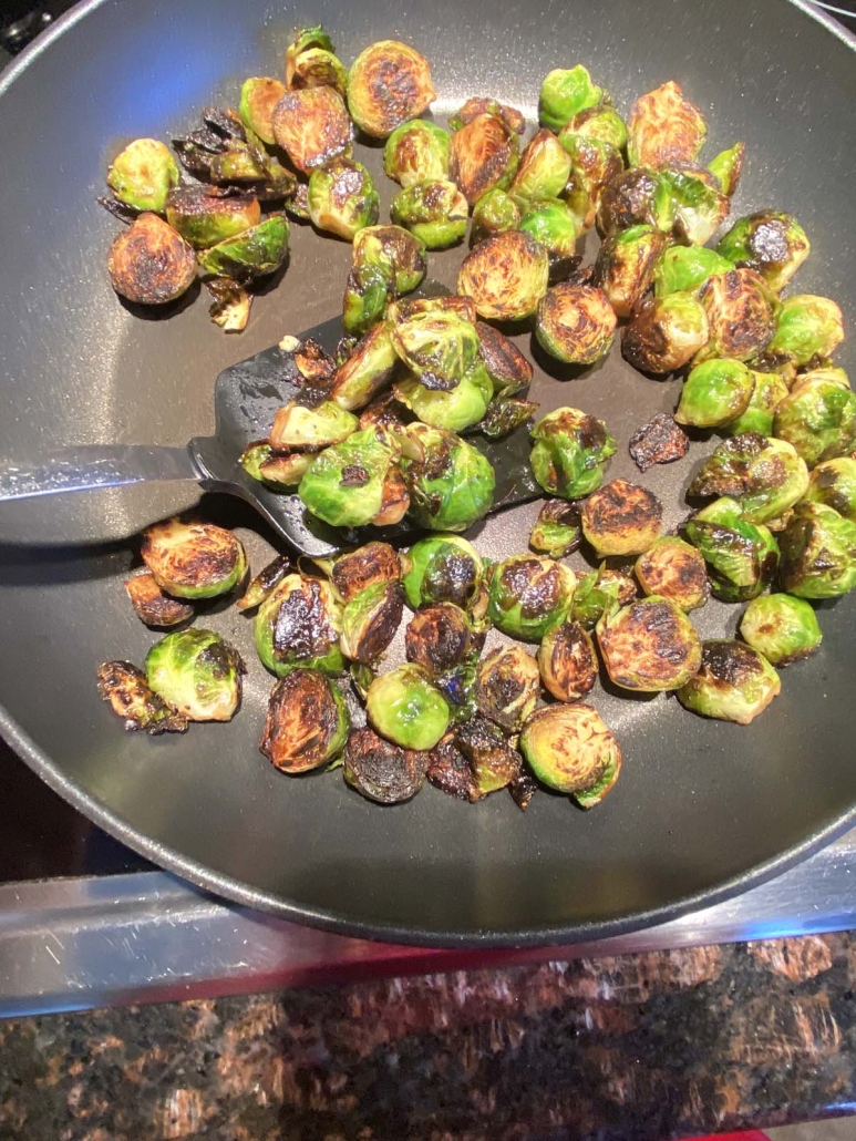 Brussels sprouts cooking in a skillet
