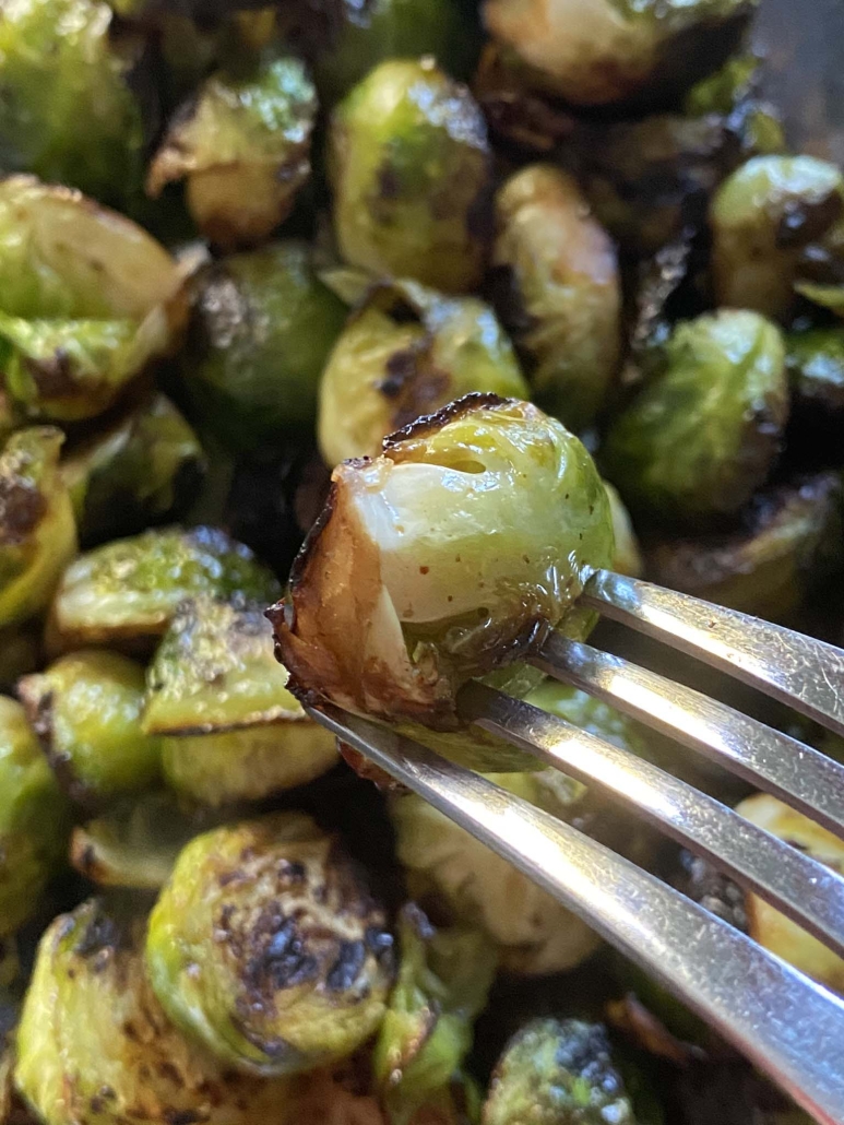 fork holding cooked Brussels sprouts