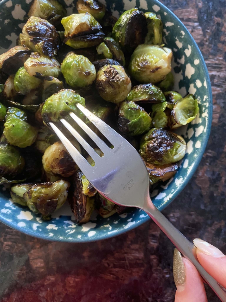 fork holding cooked Brussels sprouts