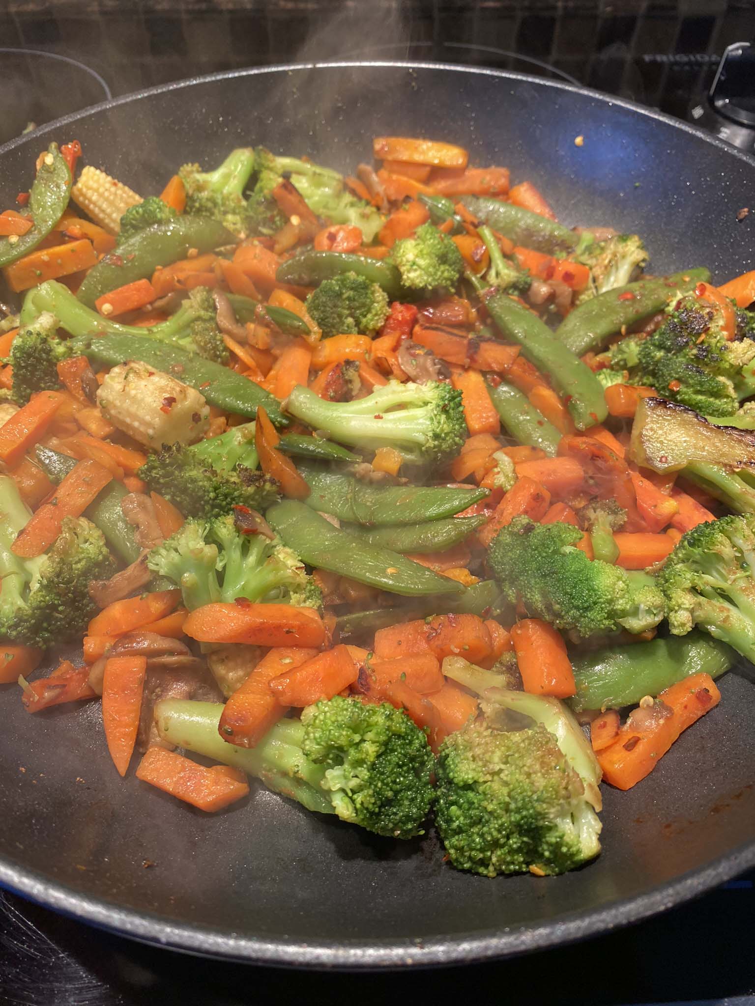 Sauteed vegetables in a pan.