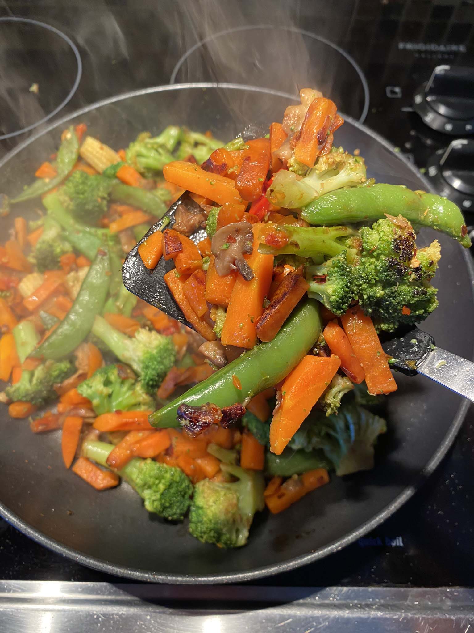 Sauteed vegetables in a frying pan.