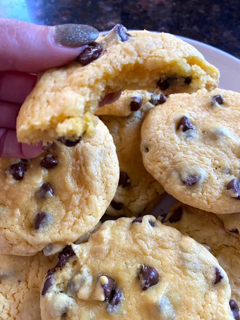 hand holding cake mix cookie with chocolate chips