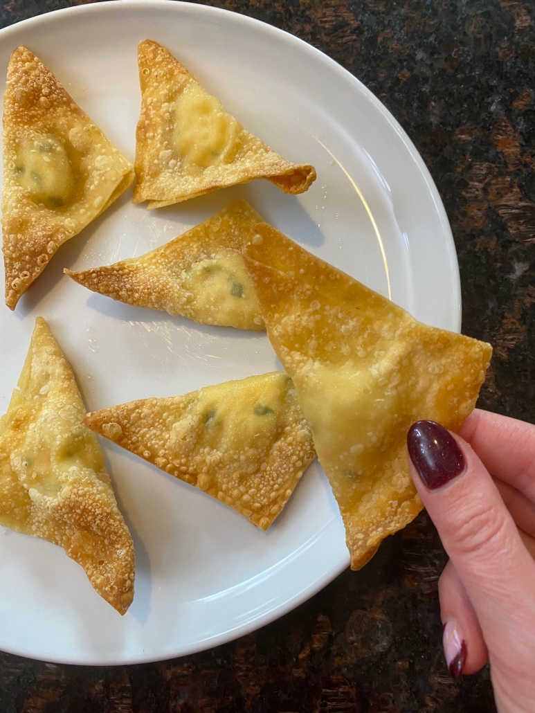 hand holding crab rangoon