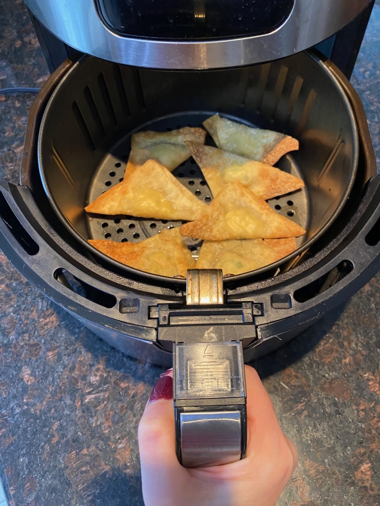air fryer opened to show cooked crab rangoon