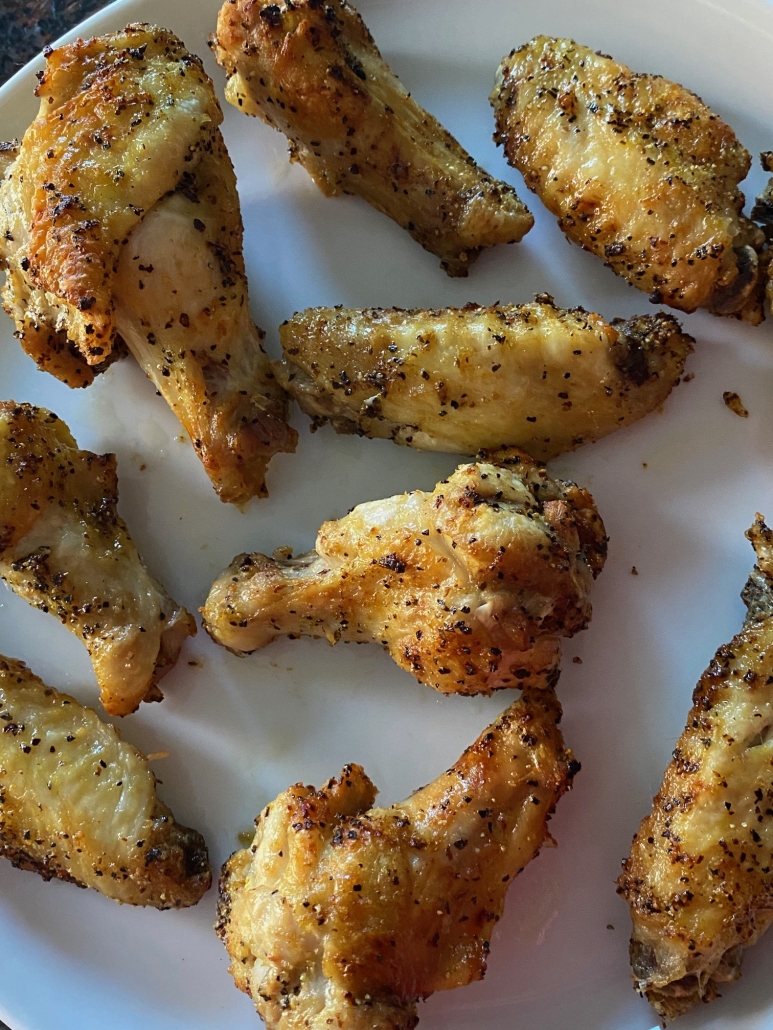 lemon pepper chicken wings laid out on a plate