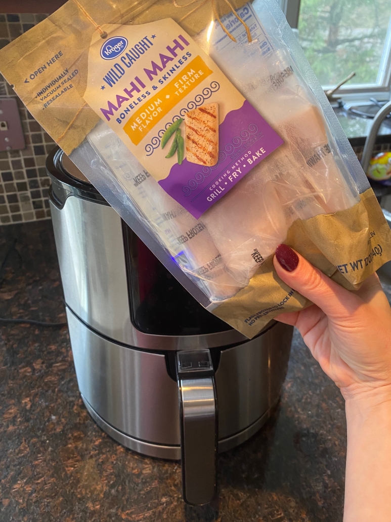 package of frozen mahi mahi in front of air fryer