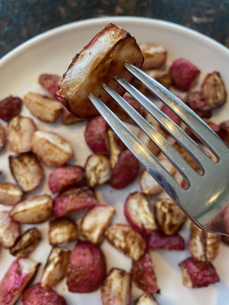 fork holding piece of roasted radish