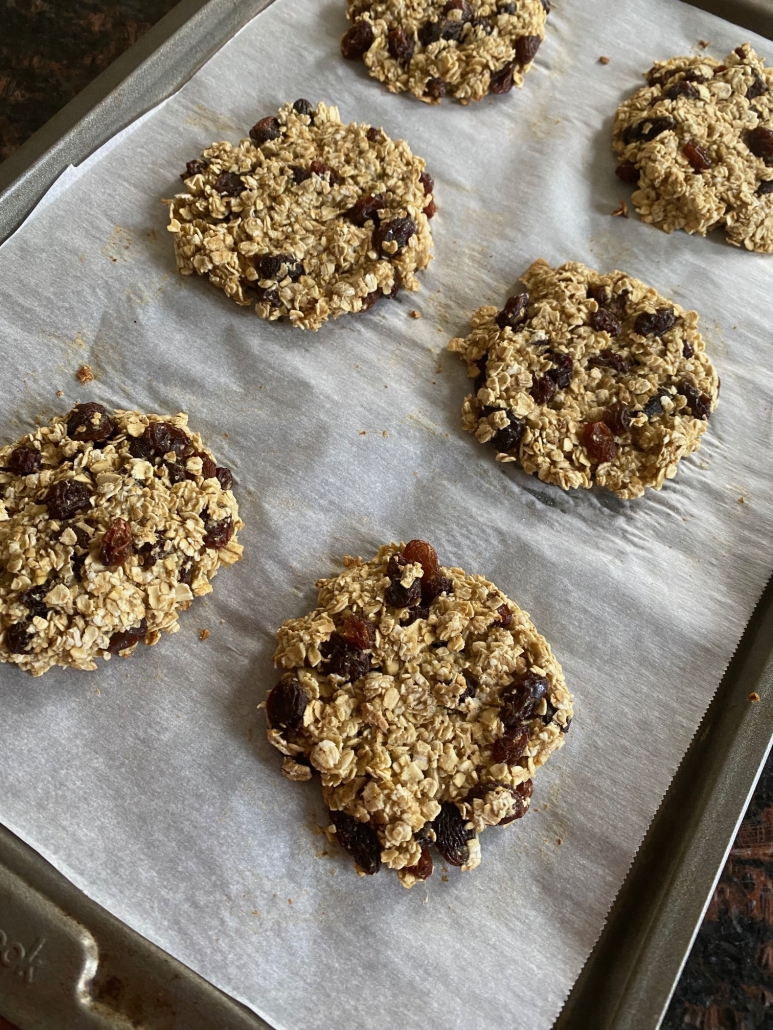 applesauce oatmeal raisin cookies laid out on baking sheet