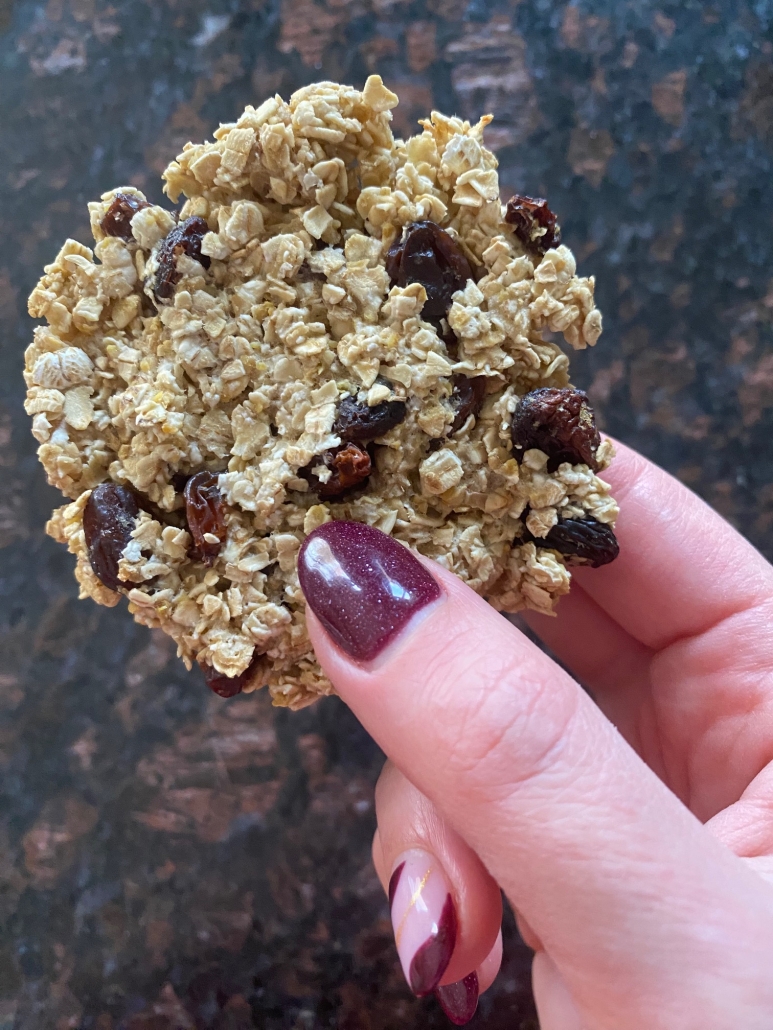 hand holding 3 ingredient applesauce oatmeal raisin cookie