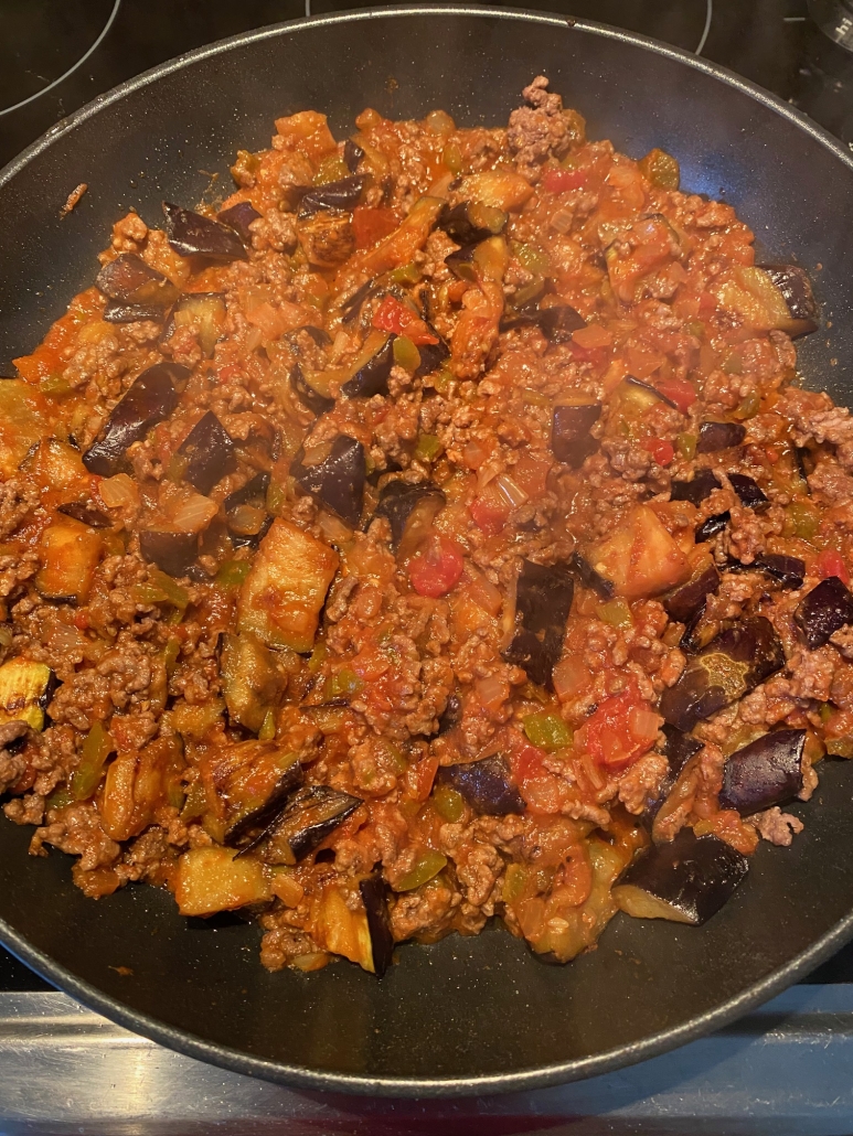 ground beef and eggplant cooking in a skillet