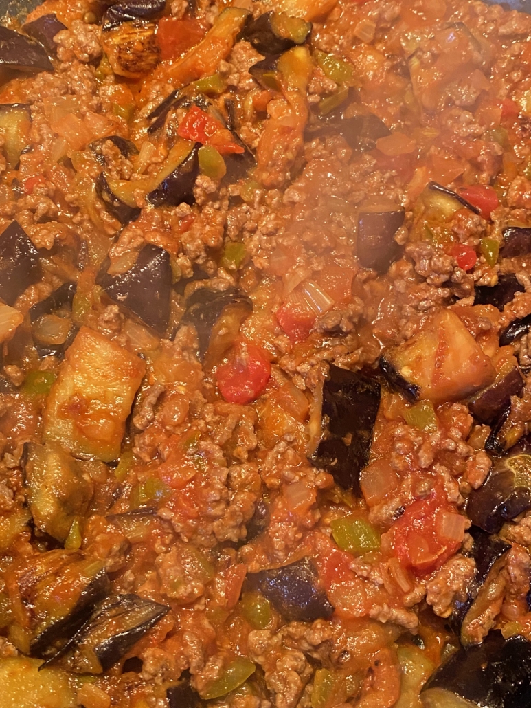 close-up of ground beef and eggplant cooking in a skillet