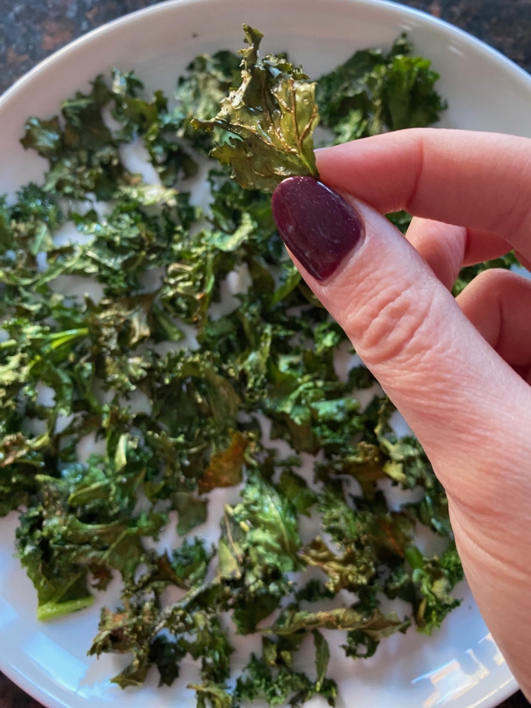 hand holding air fryer kale chip