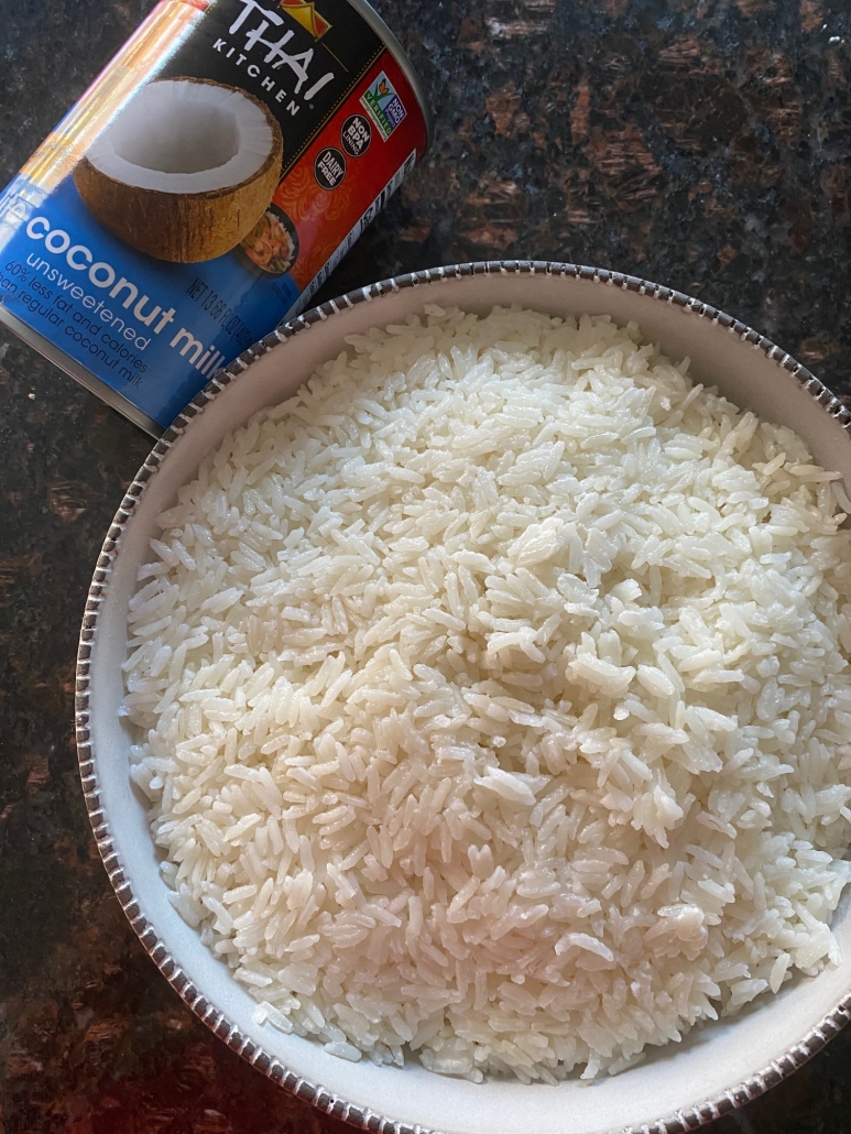 can of lite coconut milk next to bowl of coconut rice