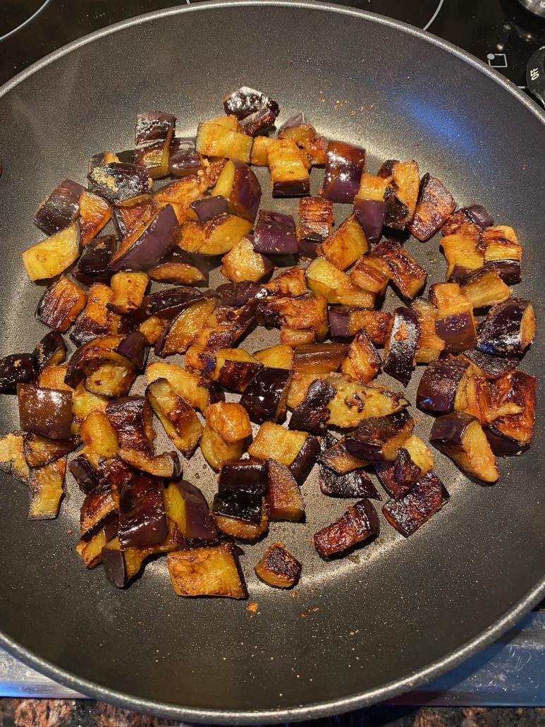 sautéed eggplant cooking in a skillet