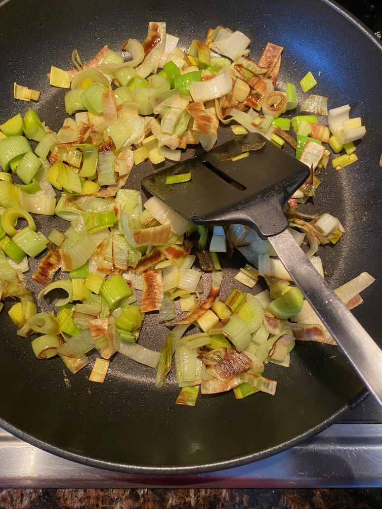 sautéed leeks cooking in pan