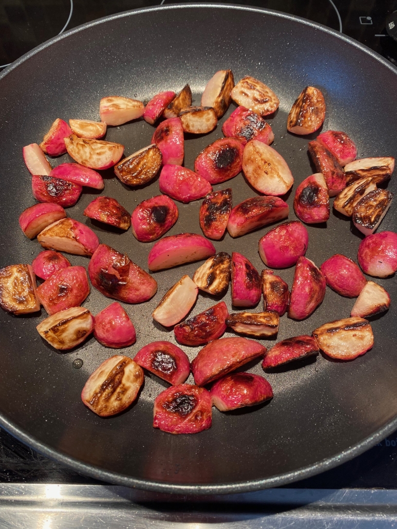 radishes sautéing in a pan