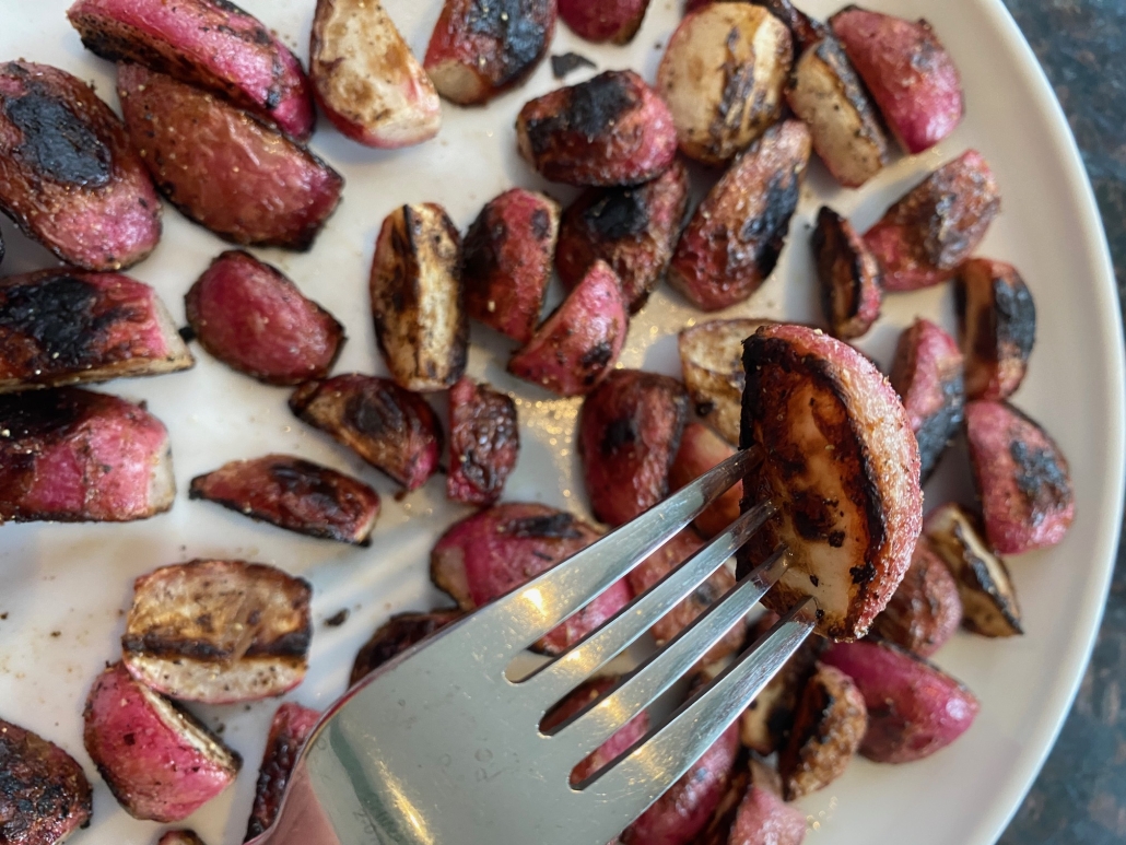 fork holding piece of cooked, seasoned radish