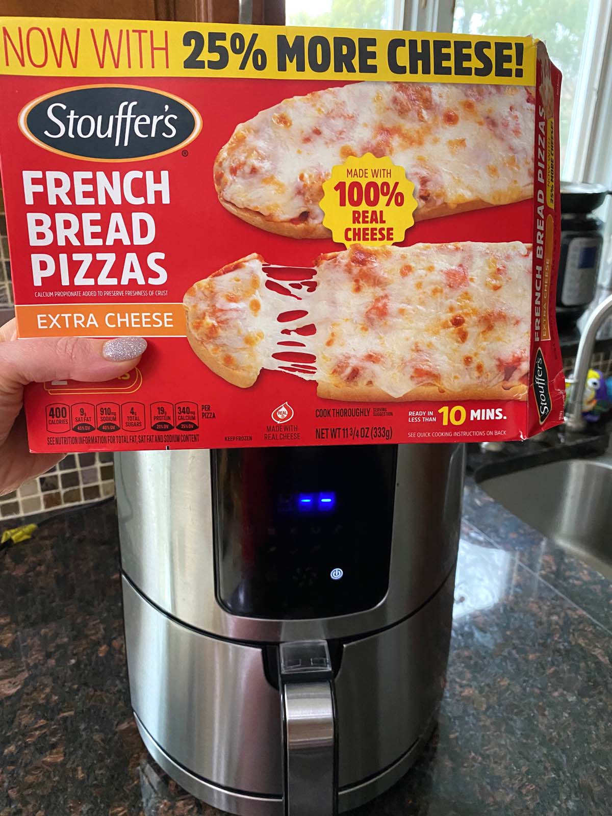 Box of French bread pizza in front of an air fryer. 