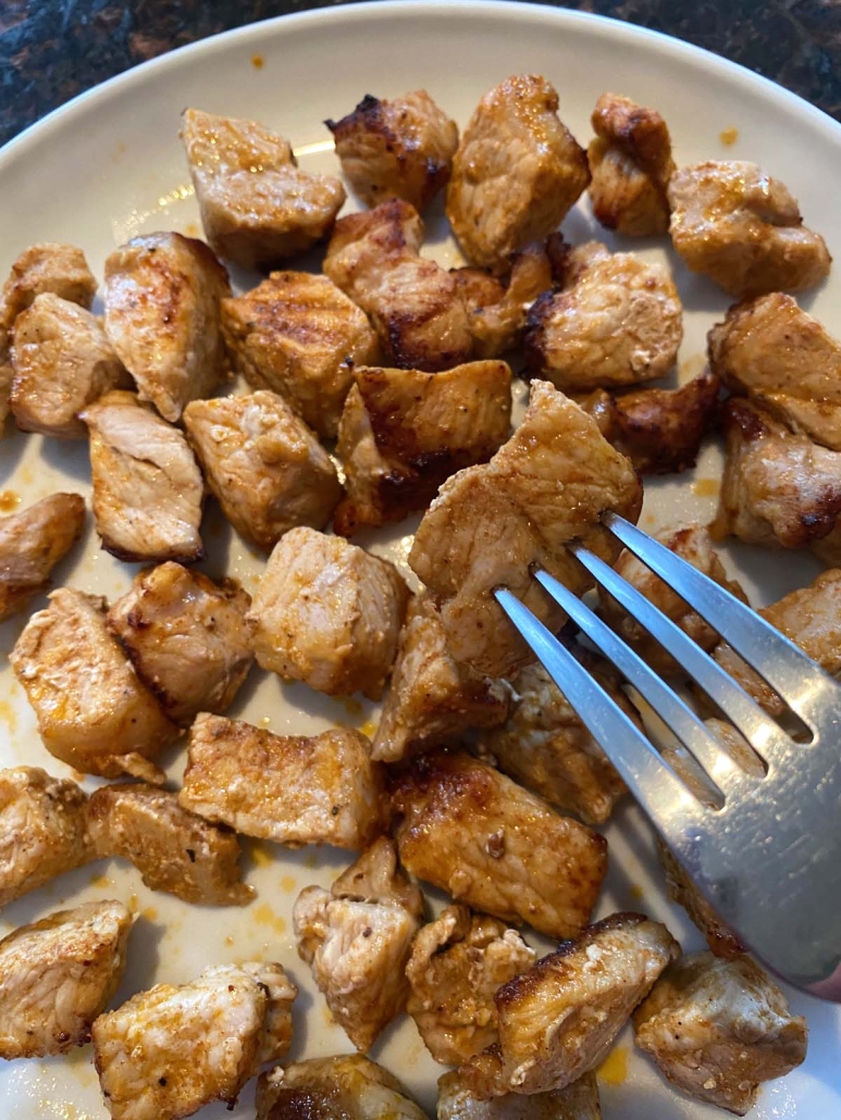 fork holding piece of Air Fryer Pork Bites