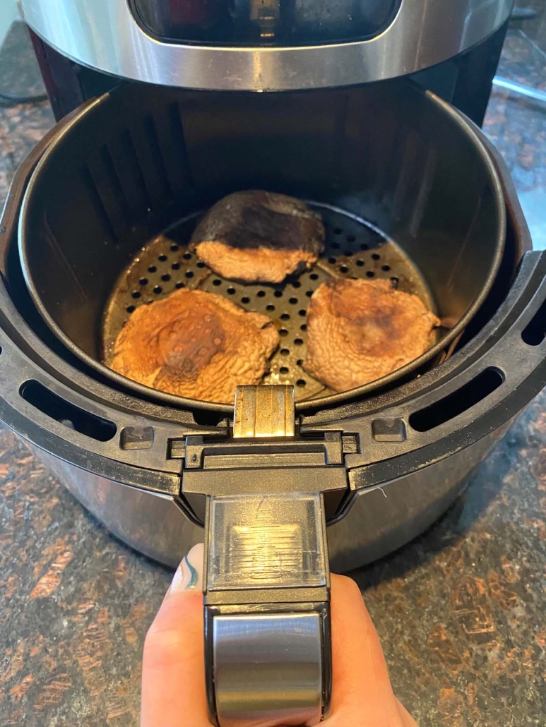 air fryer opened to show portobello mushrooms