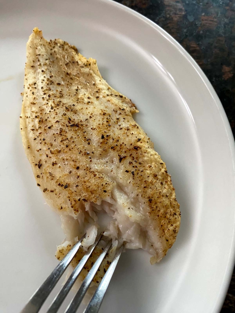 fork flaking cooked swai fish fillet