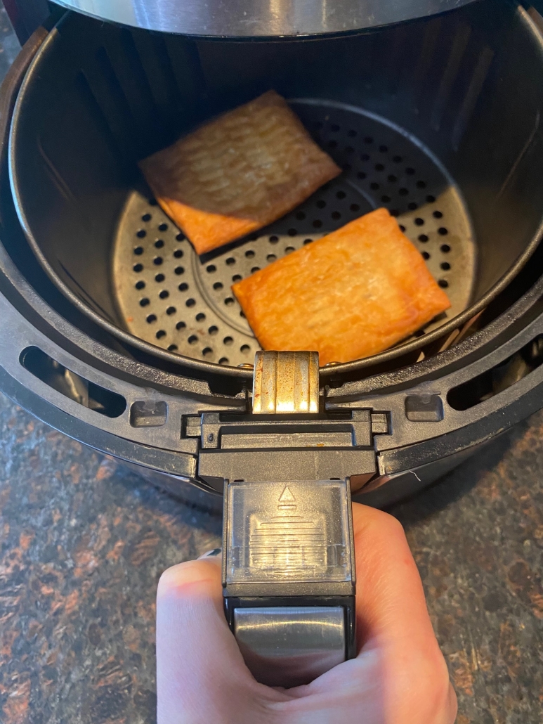 air fryer opened to show golden brown Toaster Scrambles inside