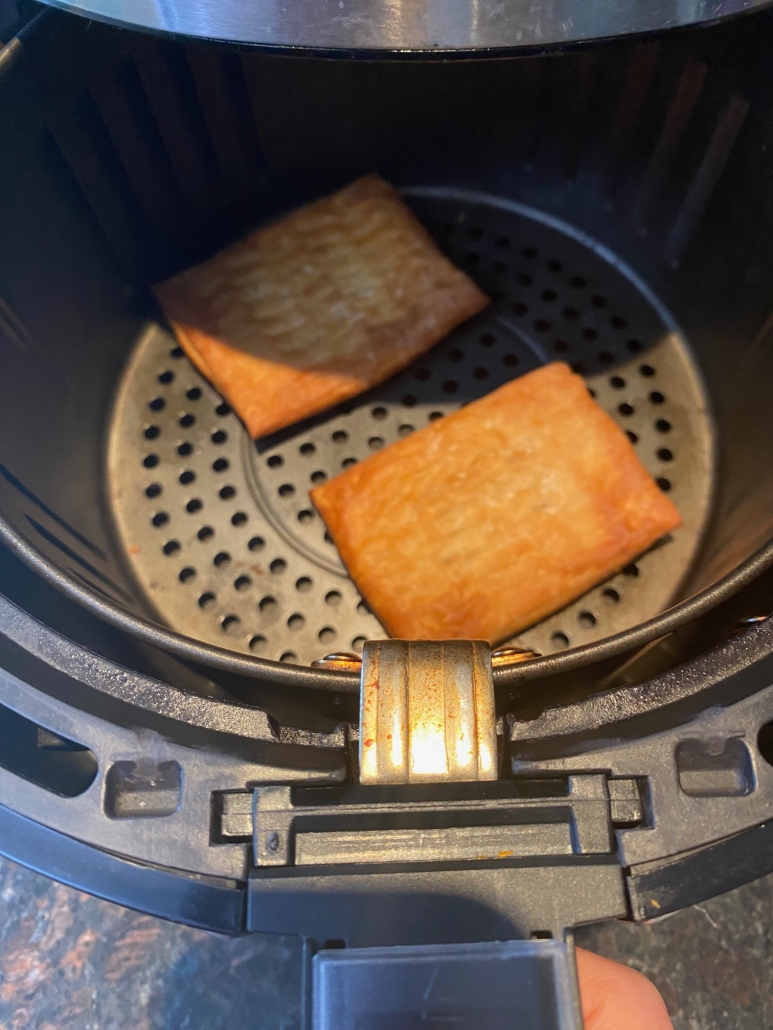 air fryer opened to show cooked Toaster Scrambles
