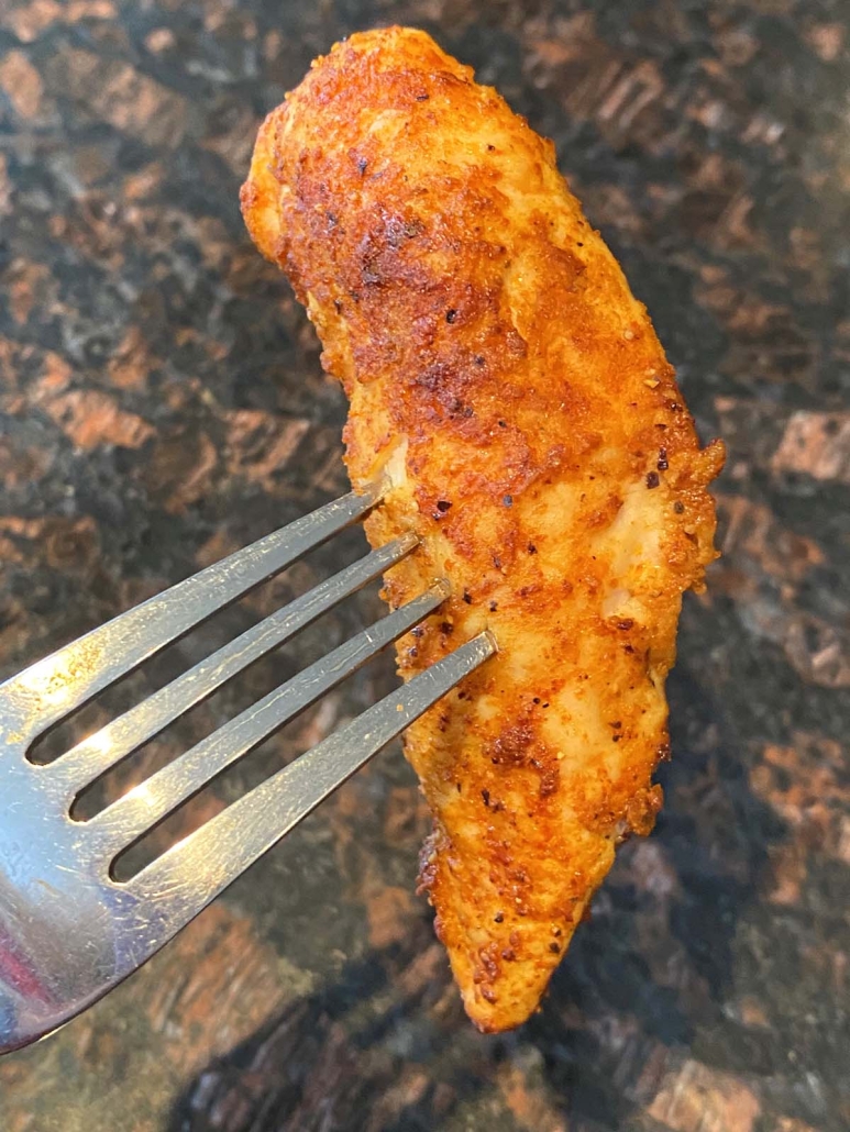 fork holding a Baked Chicken Tender with No Breading