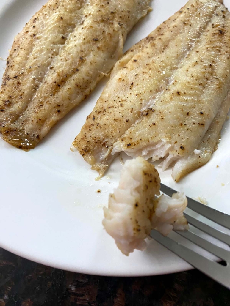 fork holding a piece of Baked Swai Fish