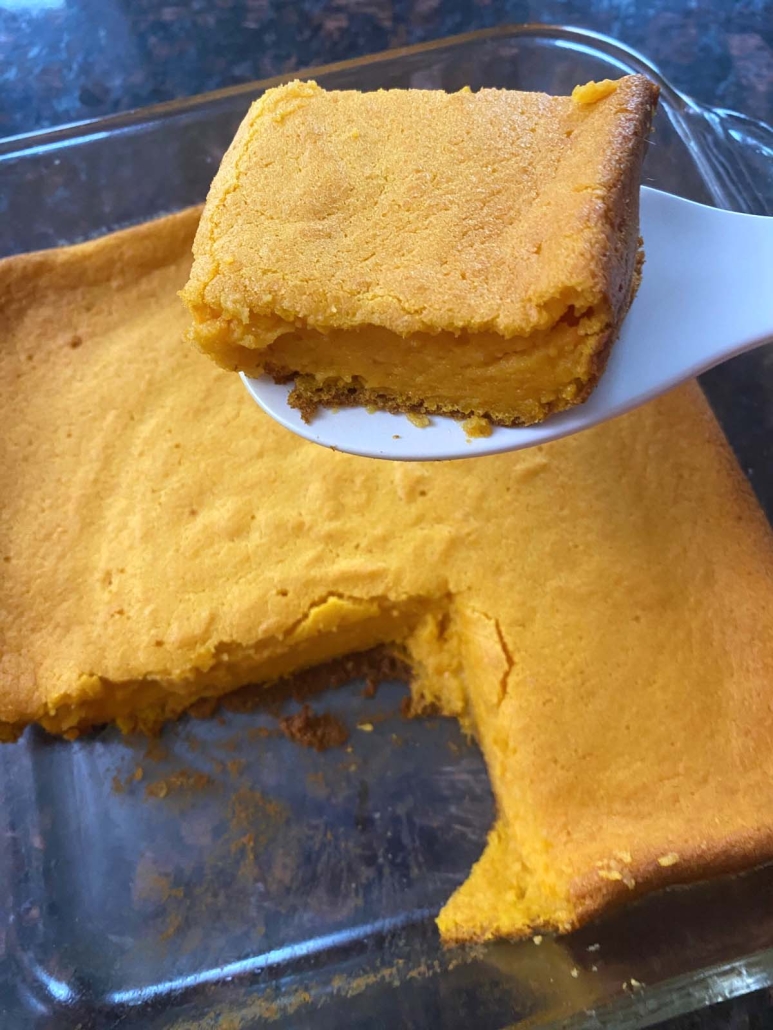 serving utensil holding slice of carrot soufflé