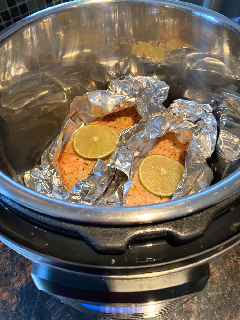 instant pot opened to show salmon in packets