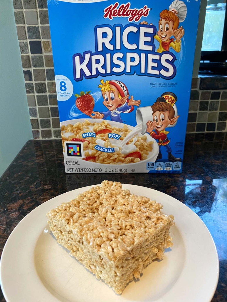 Microwave Rice Krispie Treat in front of Rice Krispies cereal