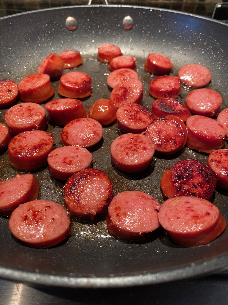 Pan Fried Kielbasa browning in a skillet