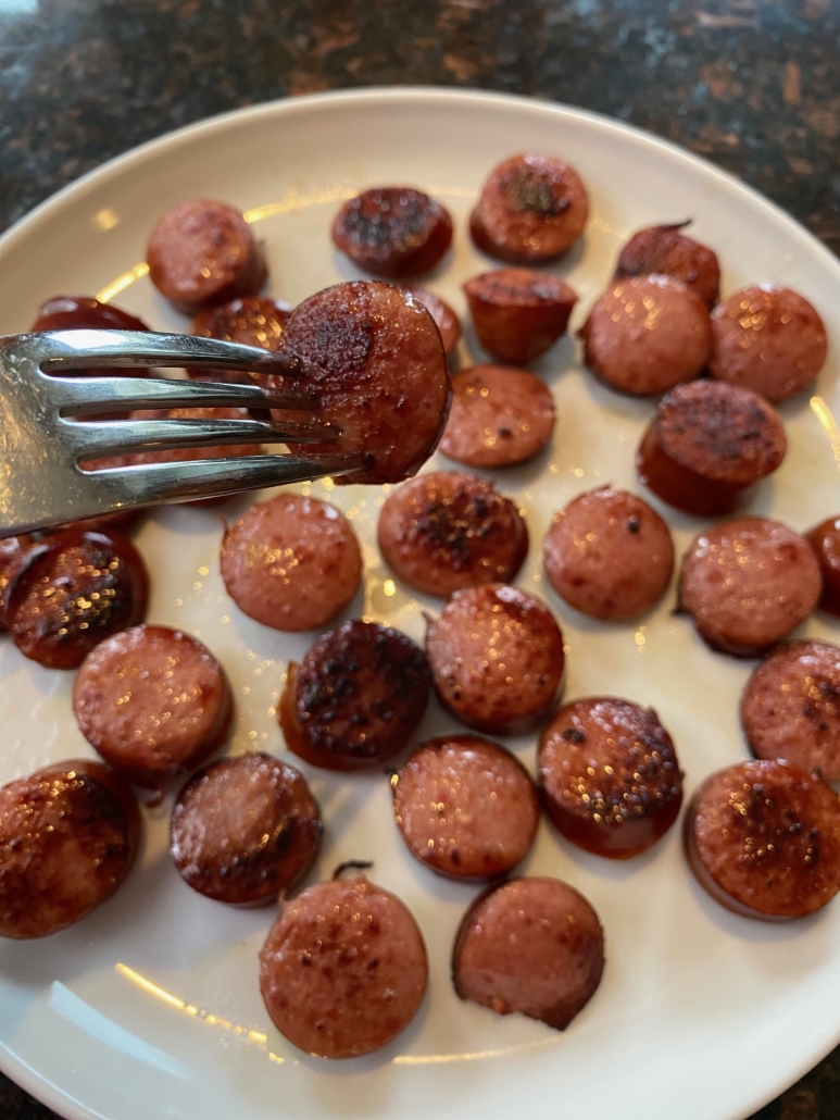 Pan Fried Kielbasa on a plate with a fork holding a piece