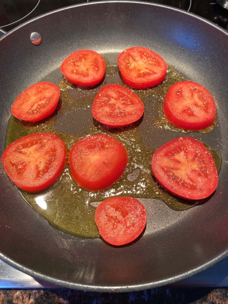 seasoned tomato slices in a pan